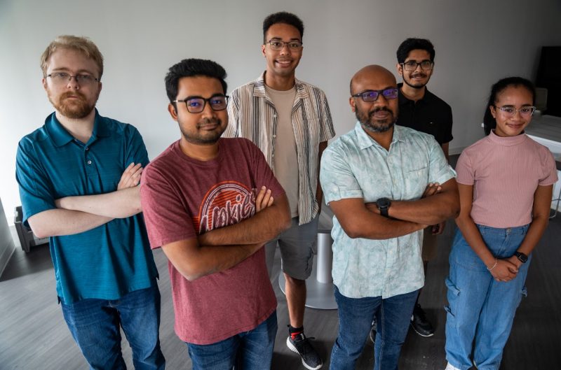Group photo of students and professor standing