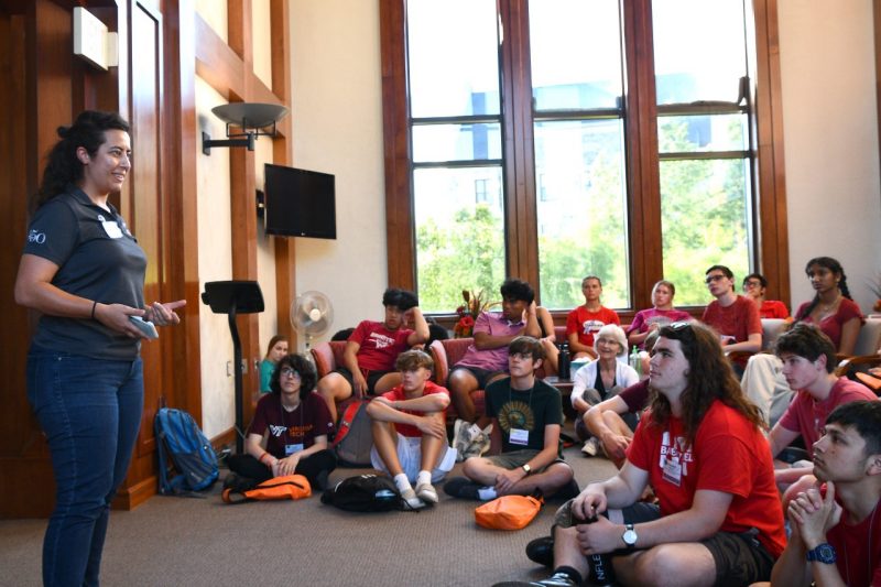 Women stands in front of group of students.