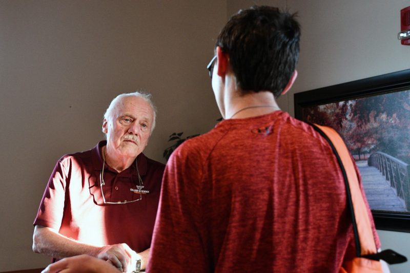 Man looking at student